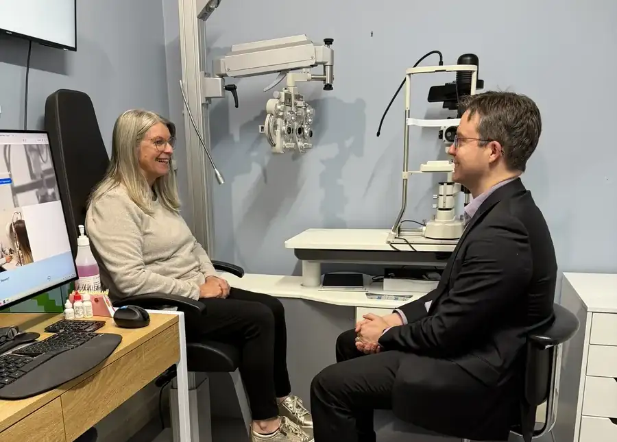 Leigh Plowman talking with a patient in the consulting room