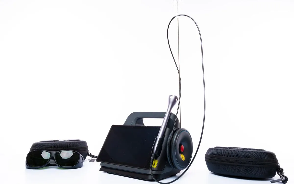 Light-based treatment device with protective goggles on a clean white surface