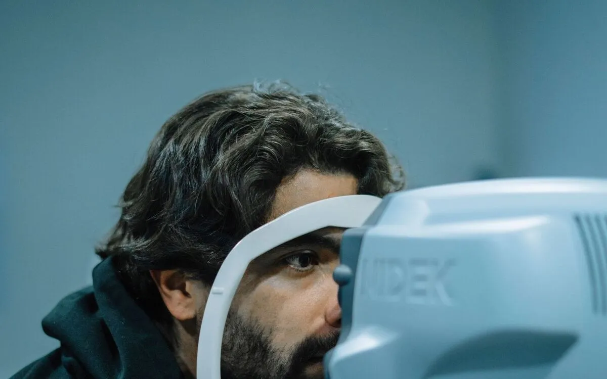 Patient resting his face on an eye-examination instrument