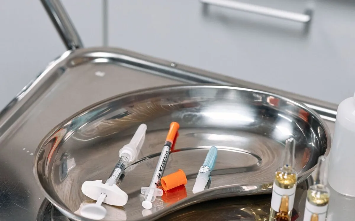 Syringes and sterile supplies on a stainless-steel tray