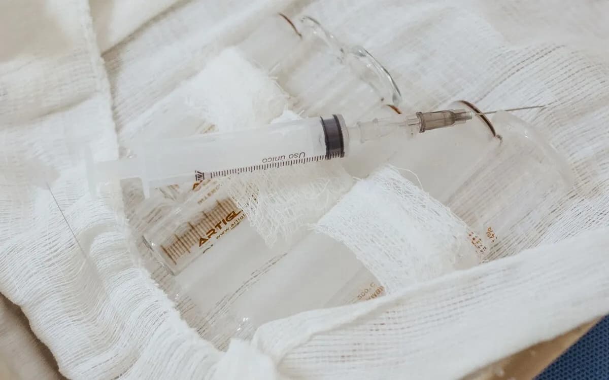 Sterile syringe resting on gauze on a clinical tray